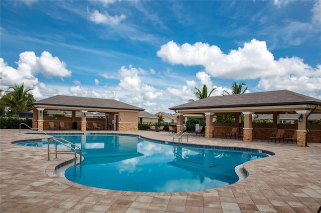 view of swimming pool with a gazebo and a patio area