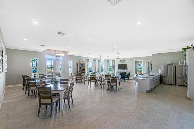 dining space with sink and light tile patterned floors