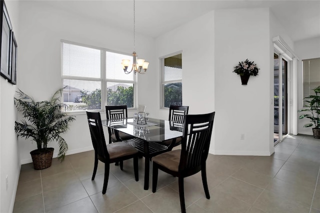 tiled dining room featuring a notable chandelier