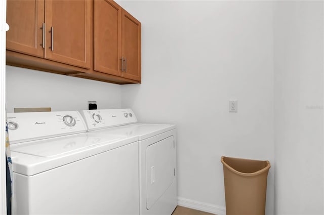 washroom with cabinets and washer and clothes dryer