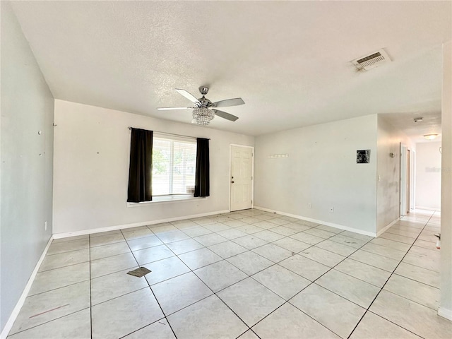 tiled spare room featuring ceiling fan