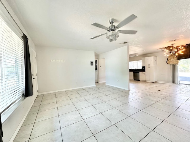 unfurnished living room featuring light tile patterned floors, sink, and ceiling fan