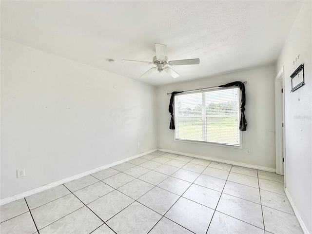 spare room with light tile patterned flooring and ceiling fan