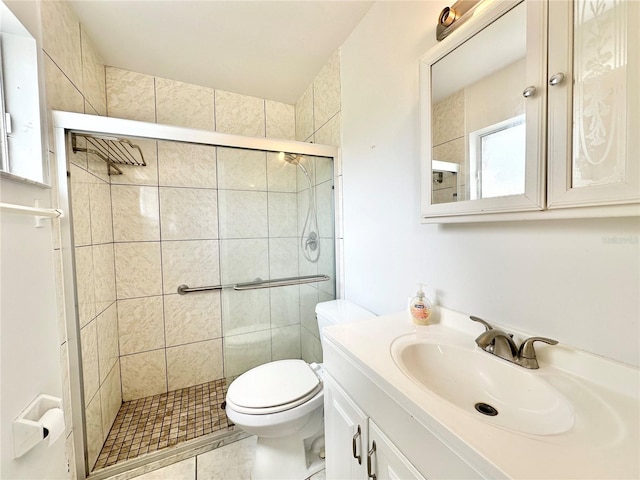 bathroom featuring toilet, an enclosed shower, tile patterned floors, and vanity