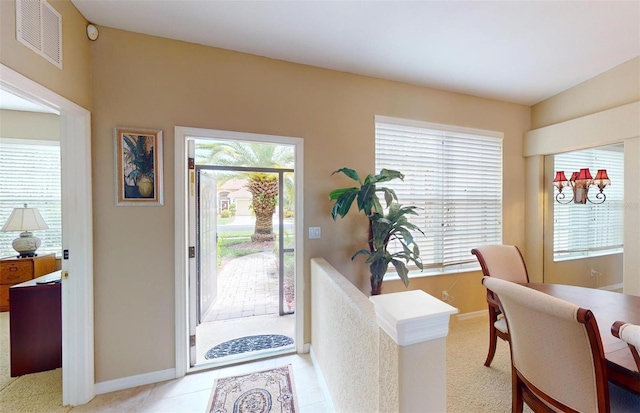 foyer entrance featuring a healthy amount of sunlight and light tile patterned floors