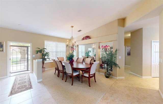 dining area featuring vaulted ceiling, a chandelier, and light tile patterned floors