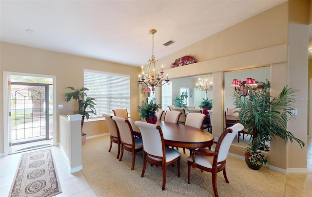 dining space featuring light tile patterned floors, a notable chandelier, and lofted ceiling