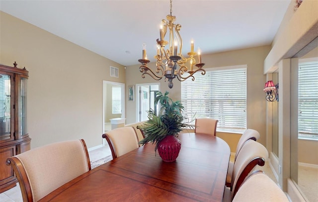 dining area with a wealth of natural light, a chandelier, and light tile patterned floors