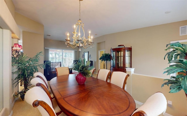 carpeted dining space featuring an inviting chandelier