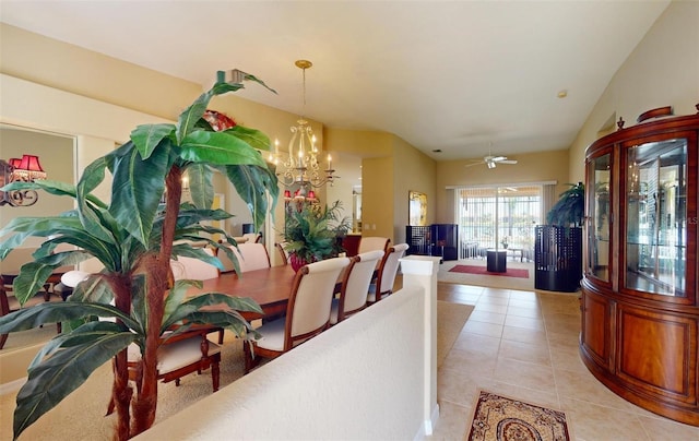 tiled dining space with ceiling fan with notable chandelier