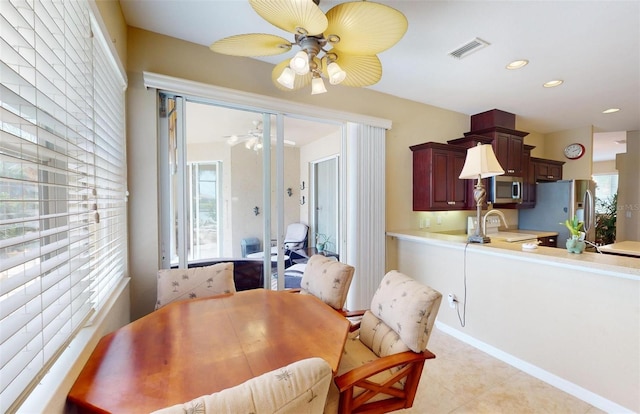 dining space featuring sink, ceiling fan, and light tile patterned floors