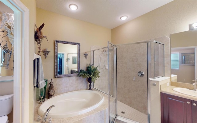 full bathroom featuring a textured ceiling, plus walk in shower, vanity, and toilet