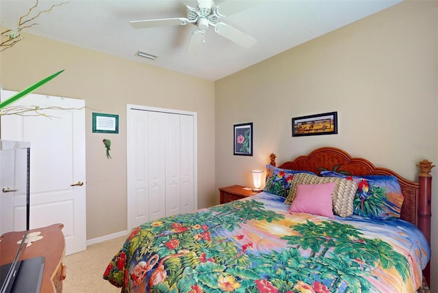 carpeted bedroom featuring a closet and ceiling fan