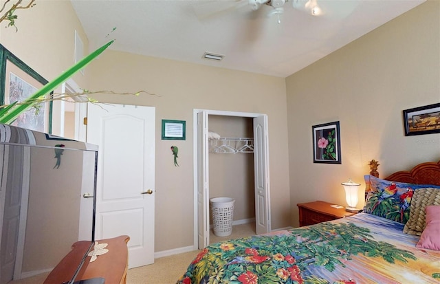 carpeted bedroom featuring ceiling fan and a closet