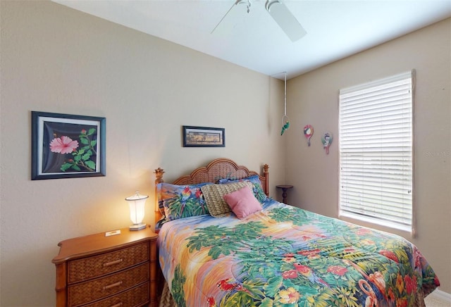 bedroom featuring multiple windows and ceiling fan