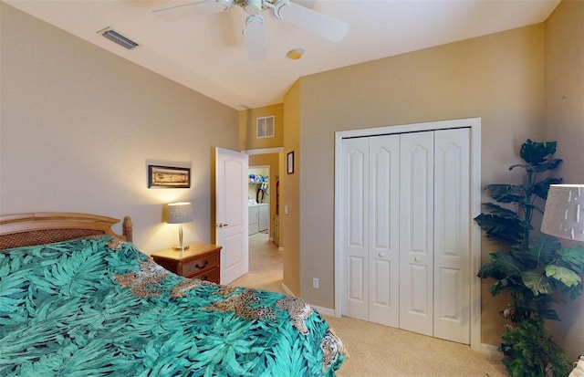 bedroom featuring ceiling fan, a closet, vaulted ceiling, and light colored carpet