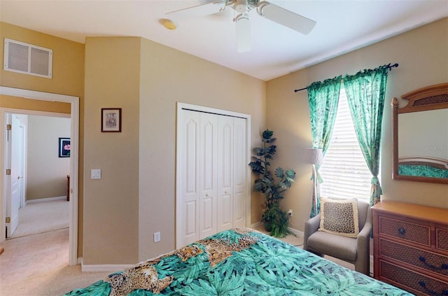 carpeted bedroom featuring ceiling fan and a closet