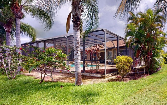 view of pool featuring glass enclosure