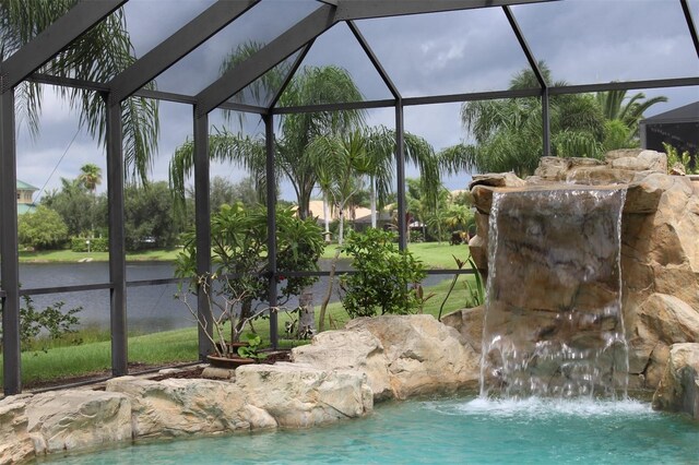 view of swimming pool with glass enclosure