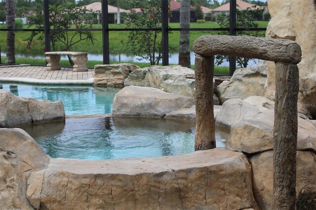 view of pool with glass enclosure