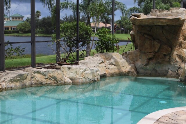 view of swimming pool with pool water feature