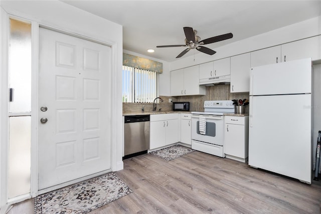 kitchen featuring light wood-type flooring, backsplash, white appliances, sink, and white cabinets