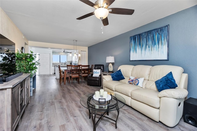 living room featuring ceiling fan and light hardwood / wood-style flooring