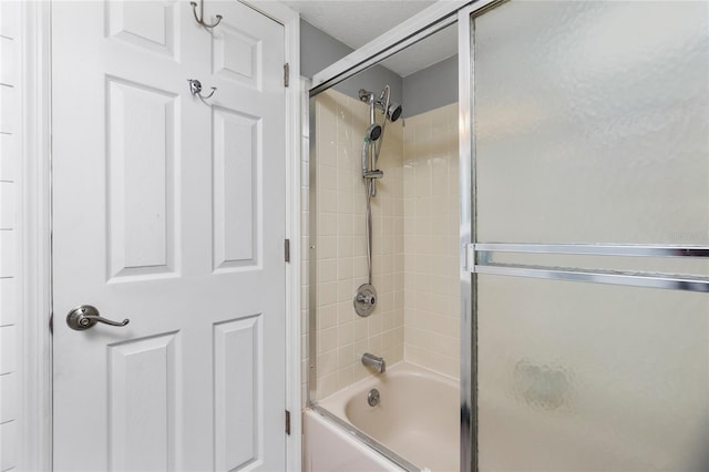 bathroom with shower / bath combination with glass door