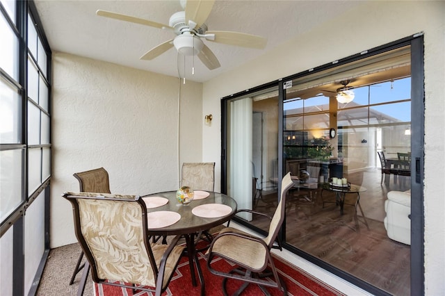 sunroom / solarium featuring ceiling fan