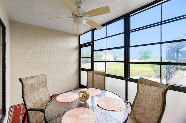 sunroom featuring ceiling fan