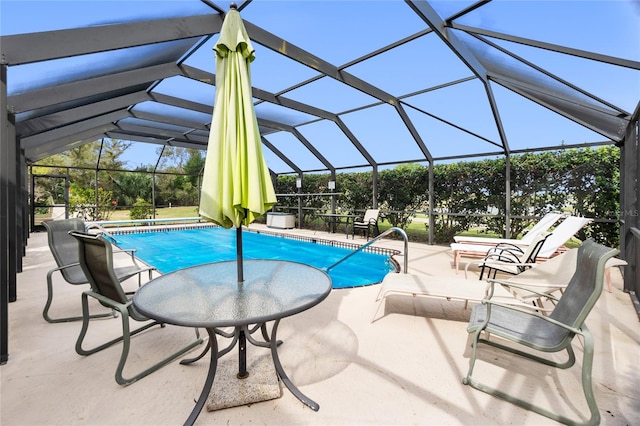 view of pool featuring glass enclosure and a patio area