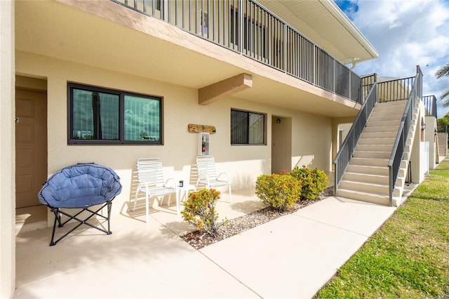 view of exterior entry with a patio