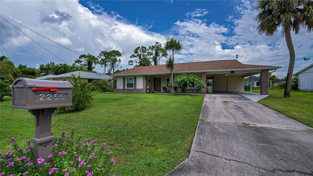 ranch-style home with an attached carport, concrete driveway, brick siding, and a front lawn