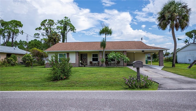 ranch-style house featuring a carport, a front yard, and driveway