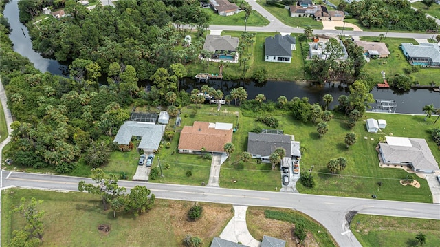 drone / aerial view featuring a water view and a residential view