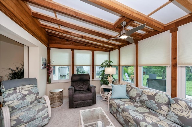 interior space with ceiling fan, vaulted ceiling with skylight, and carpet flooring