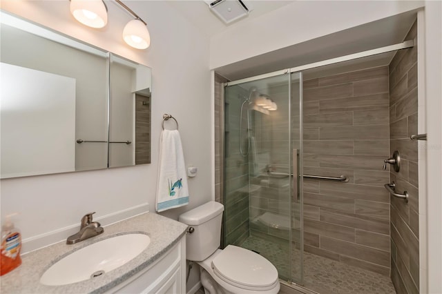 bathroom with a stall shower, visible vents, vanity, and toilet