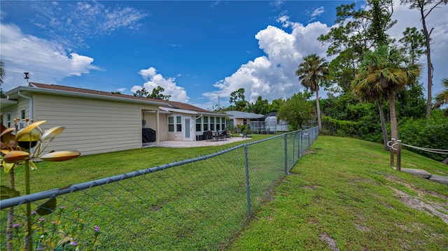 back of house featuring a patio, a lawn, and a fenced backyard