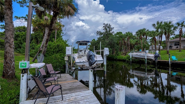 dock area with a water view and boat lift