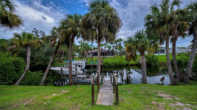 dock area featuring a lawn and a water view