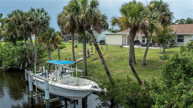 dock area featuring a water view, fence, and boat lift