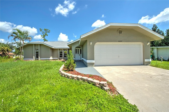 single story home with a garage and a front lawn