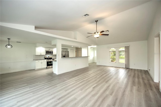 unfurnished living room with ceiling fan, light wood-type flooring, and high vaulted ceiling