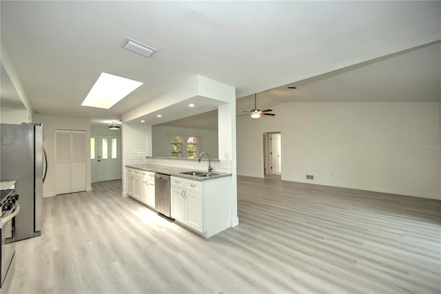 kitchen featuring sink, white cabinetry, light wood-type flooring, ceiling fan, and stainless steel appliances