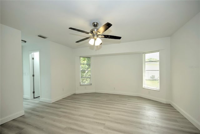 spare room featuring light hardwood / wood-style floors and ceiling fan