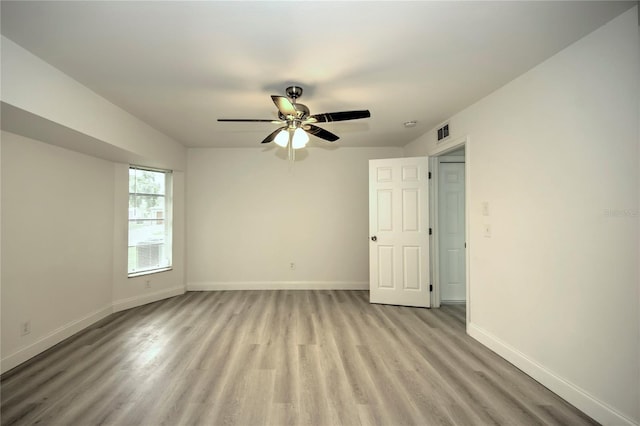 empty room featuring ceiling fan and light wood-type flooring