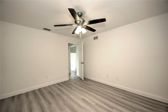 empty room featuring ceiling fan and light hardwood / wood-style flooring