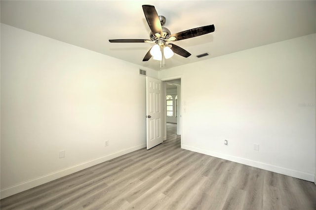 empty room featuring light wood-type flooring and ceiling fan