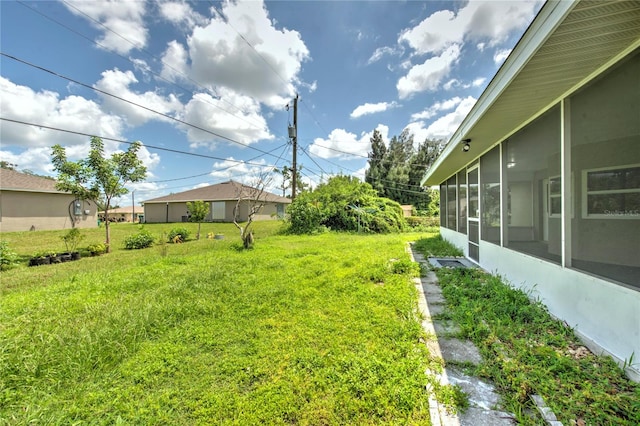 view of yard featuring a sunroom