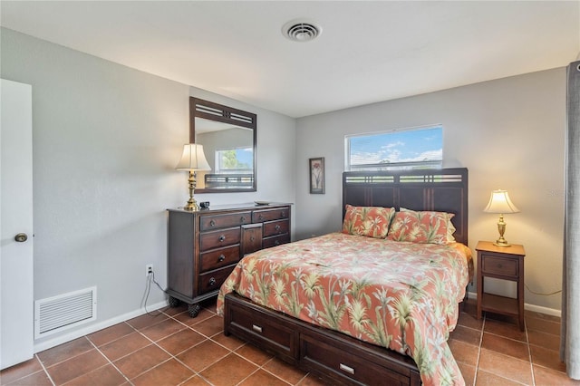 bedroom with tile patterned flooring and multiple windows